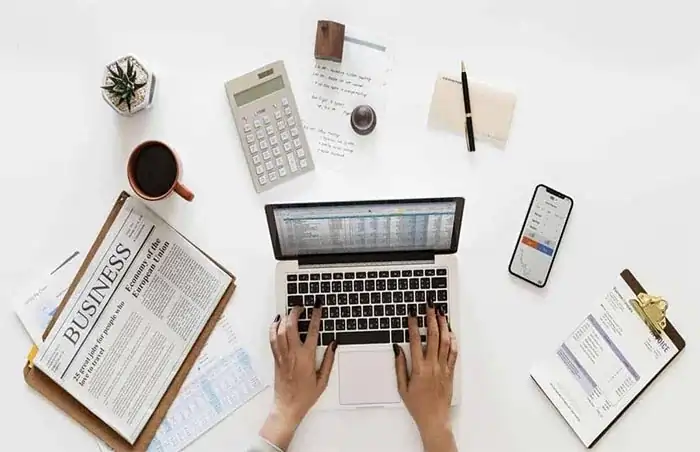 Top view of workspace with laptop and items representing email management in DatumOffice